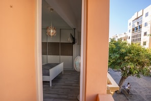 A bedroom with a bed, a ceiling fan, and a view of the outside. - 3-Bedroom Smile Family Home (Los Llanos de Aridane)