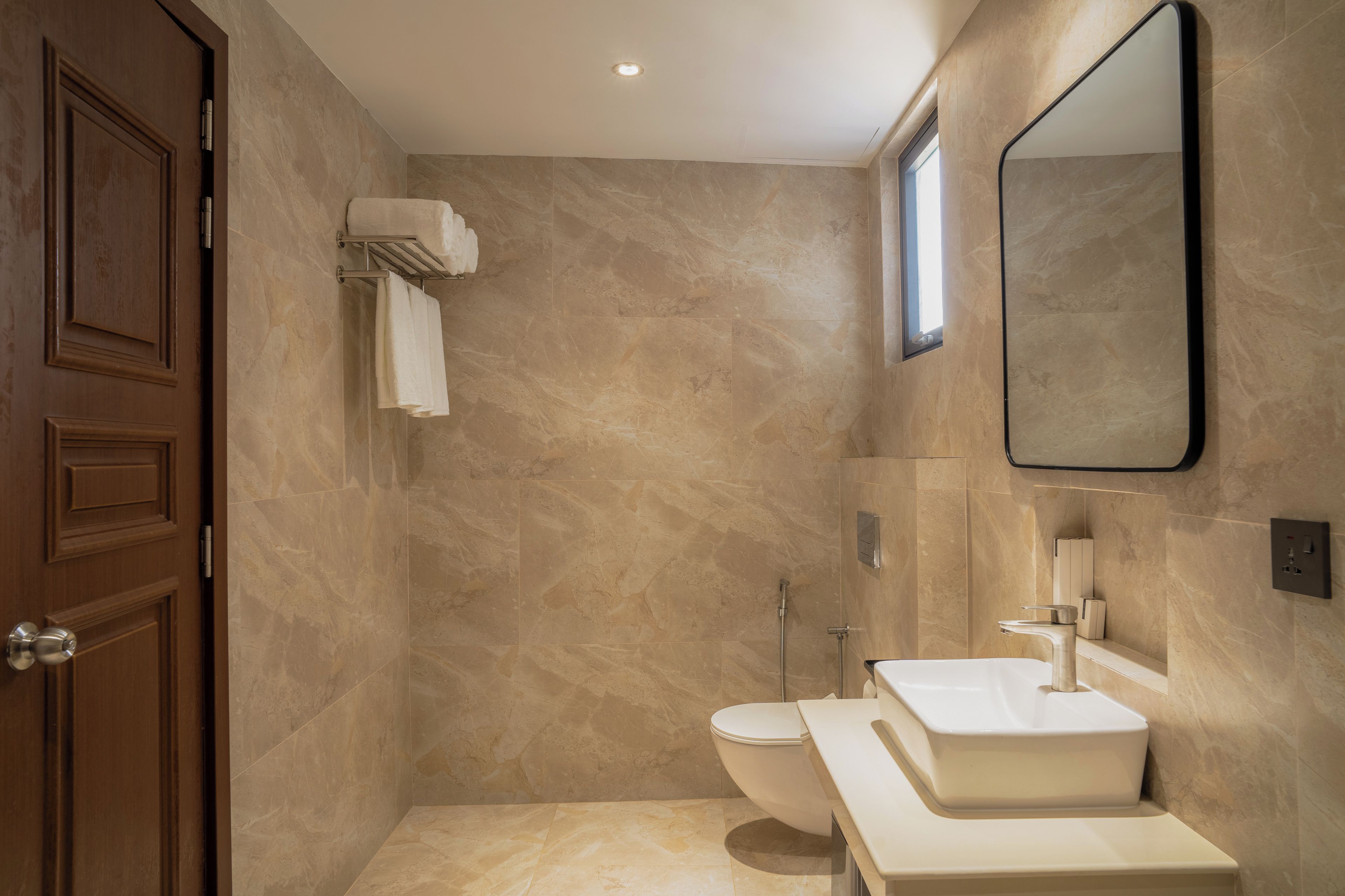 A bathroom with a toilet, sink, and shower.