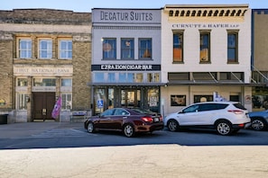 A street view with buildings including Decatur Suites, EZRAZION Cigar Bar, and Burnt & Hafer, LLP.