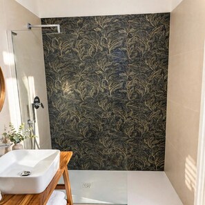 A bathroom with a white sink, a glass shower enclosure, and a dark patterned wall. - MANETTI ROOMS Double Room on Via Chiaia, 600 meters from the waterfront. (Napoli)