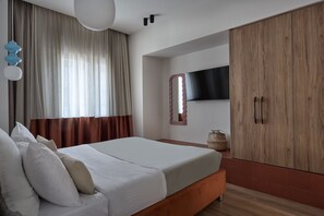A bedroom with a bed, curtains, a television, and a wardrobe. - Modern 2BD Apartment near Acropolis by Lumen Living (Athina)