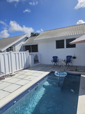 A swimming pool with a tiled edge, a white fence, and two blue chairs. - Welcoming 3-bedroom house that is a 4 min walk to beach (Prospect)