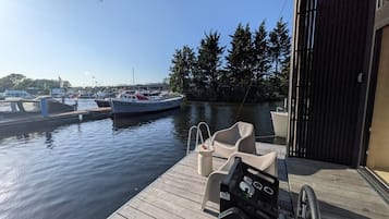 En træbrygge med en båd kaldet 'Echizen' i lysthavnen, omgivet af træer og andre både.