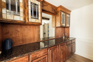 A kitchen with wooden cabinets, a granite countertop, and a stainless steel sink. - Historic Old Town condo with 3 bedrooms, 3 baths, sleeps 10. (Park City)