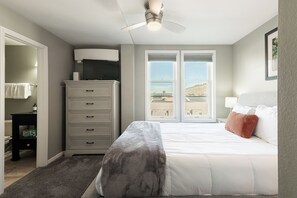 A bedroom with a bed, a dresser, a ceiling fan, and a window with a view. - Historic Old Town condo with 3 bedrooms, 3 baths, sleeps 10. (Park City)