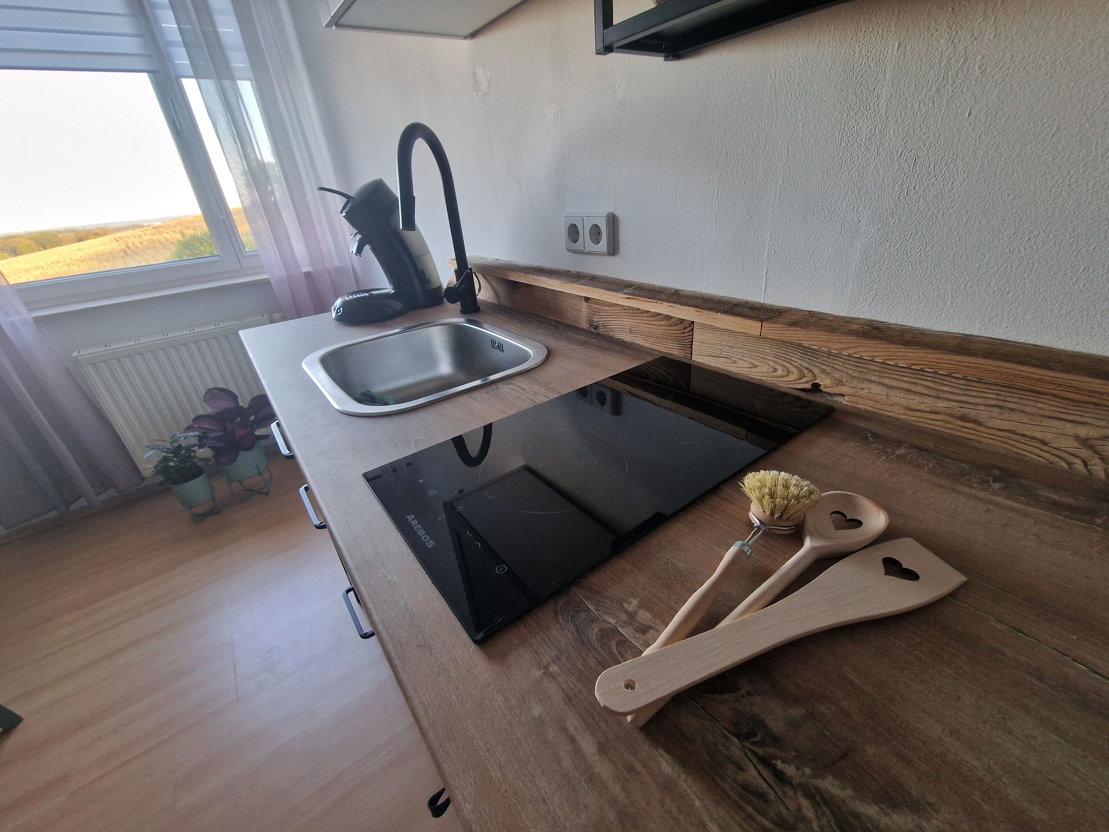 A kitchen with a built-in sink, a stove, and wooden countertops.