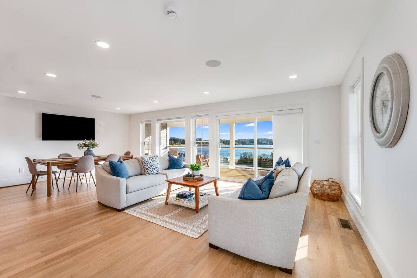 A spacious living room with a sofa, coffee table, and dining area.