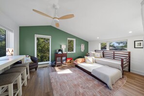 A bedroom with a bed, desk, chair, and a ceiling fan. - Chapel Cove Waterfront Home near Whitewater Lake (Whitewater)