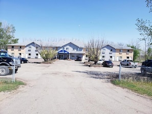 A Travel Inn hotel with a parking lot and multiple vehicles.