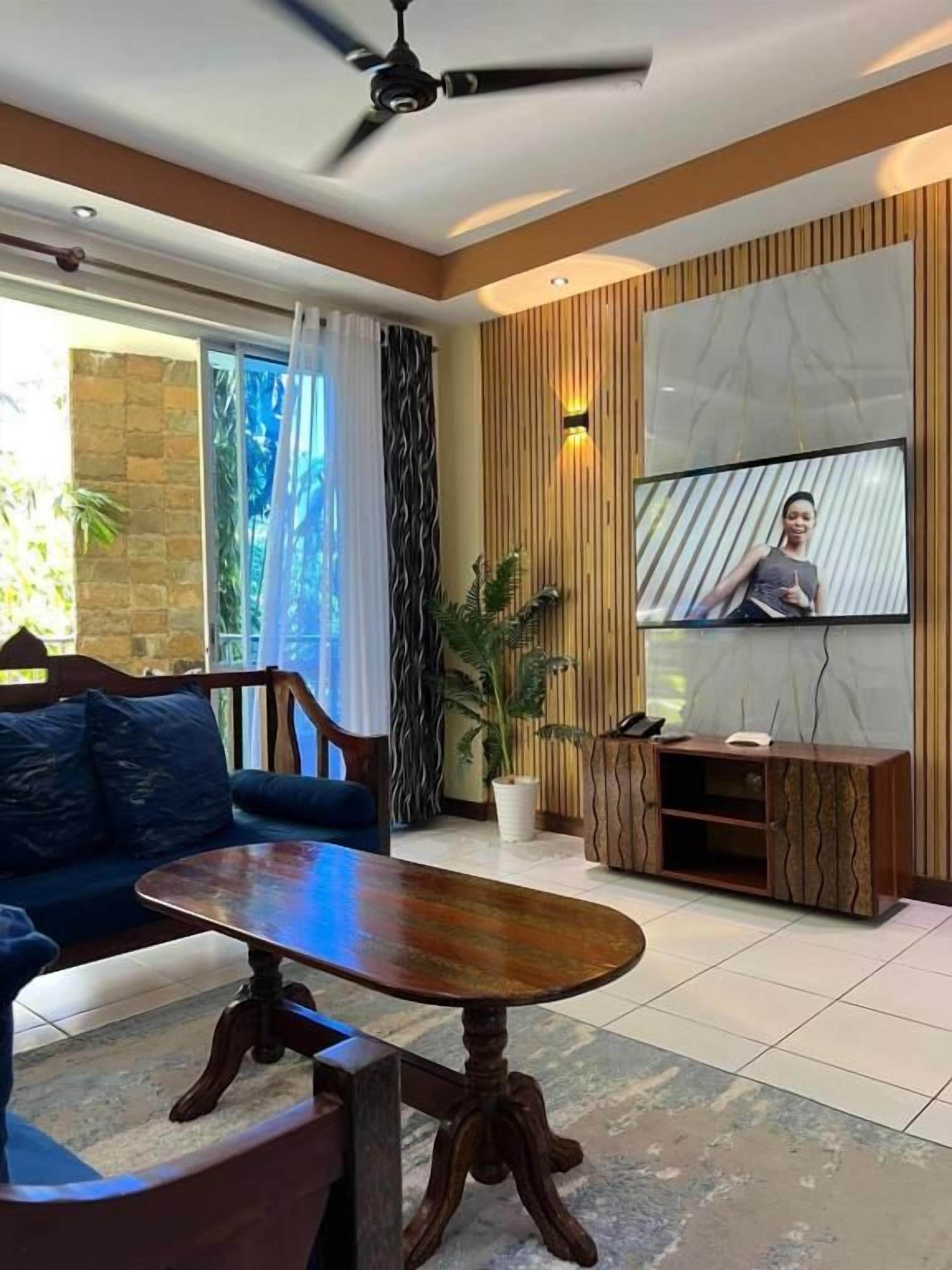 A modern living room with a sofa, coffee table, and TV.