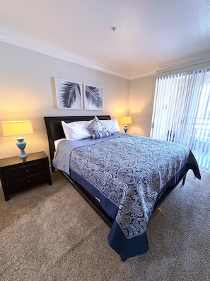 A hotel room with a large bed, two bedside tables with lamps, a headboard, and a window with blinds. - Luxury Las Vegas Strip!  1BR Private Residences Condo ~ 24/7 Pool 2-03 (Las Vegas)