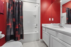 A bathroom with a shower, toilet, and sink. - Resort Mansion, sleep 36, pool spa & game room (Davenport)