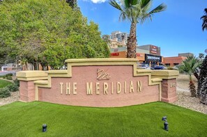 A sign for 'The Meridian' with a brick base and a clear sky in the background. - Luxury Las Vegas Strip!  1BR Private Residences Condo ~ 24/7 Pool 2-22 (Las Vegas)