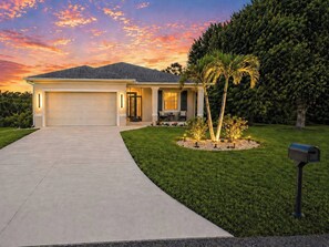 A single-story house with a garage, a well-maintained lawn, and a mailbox. - Heated Saltwater Pool | Near Beach | Pets Welcome! (Rotonda West)