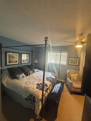 A bedroom with a four-poster bed, a chair, and a bench. - Sea Horse Beach House 2BR 3BA Sleep7,with Pool Near Cherry Grove4Mile From Beach (Little River)