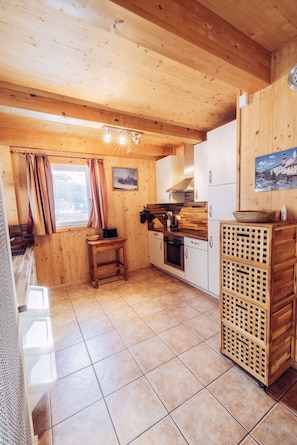 A compact kitchen with wooden cabinets, a stove, and a sink. - 026 W6 in St Georgen am Kreischberg (Sankt Georgen am Kreischberg)