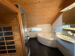 A modern bathroom with a freestanding bathtub, a glass shower enclosure, and a large mirror. - 011 Mw21a in Murau (Murau)