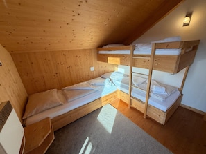 A compact wooden room with bunk beds, a small desk, and a radiator. - 011 Mw21a in Murau (Murau)