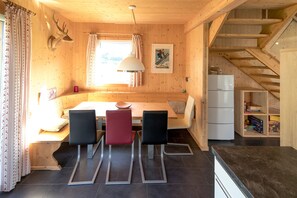 A wooden interior with a dining area, a kitchen, and a staircase. - 006 Mw13 in Murau (Murau)
