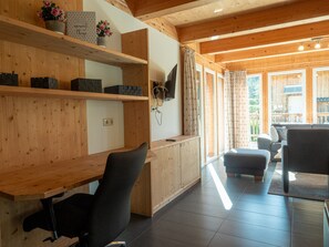 A wooden interior with a desk, chair, and a sofa. - 001 MW1 in Murau (Murau)
