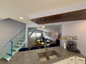 A kitchen with granite countertops, a built-in sink, and a coffee maker. - Massage Chair! Stay at Love Shack by the Beach -under a block to Park or Beach (Port Clinton)