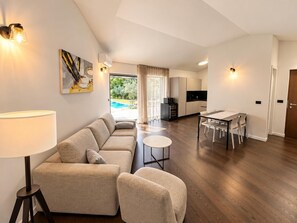 A modern living room with a sofa, a dining table, and a kitchen area. - Villa Casa Vesta - Two Bedroom Villa, Sleeps 4 (Sveti Ivan)