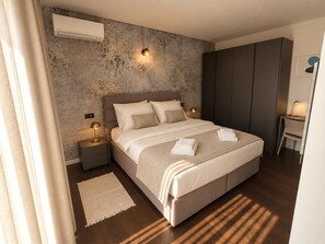A modern bedroom with a large bed, bedside lamps, a desk, and a wardrobe. - Villa Casa Veritas - Four Bedroom Villa, Sleeps 8 (Sveti Ivan)