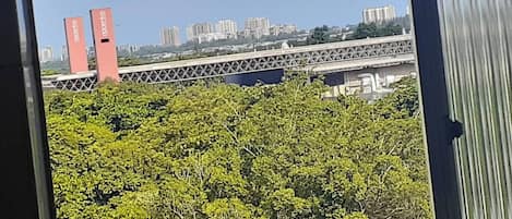 A view of a bridge with buildings in the background.