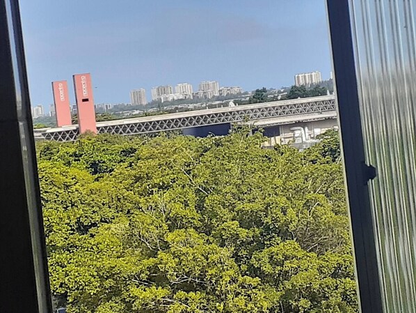 A view of a bridge with buildings in the background.