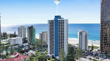 A high-rise hotel with a prominent 'Long Beach' sign, surrounded by other buildings and a beach.