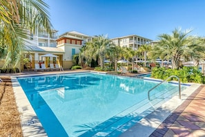 A swimming pool with lounge chairs and umbrellas, surrounded by palm trees and buildings. - ⭐Palms By The Sea | Rooftop Deck | Pool | Beach Access⭐ (Seacrest Beach)