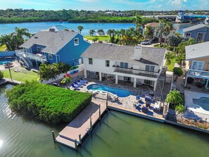 A residential property with a swimming pool, a dock, and a view of a body of water. - Amazing Waterfront Home 2 Blks 2 Beach & Food (Indian Rocks Beach)