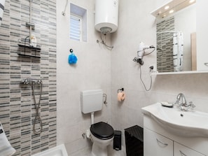 A bathroom with a shower, toilet, sink, and a window. - Apartments Sun 4 You - Two Bedroom Apartment With Balcony and Sea View (Karlobag)