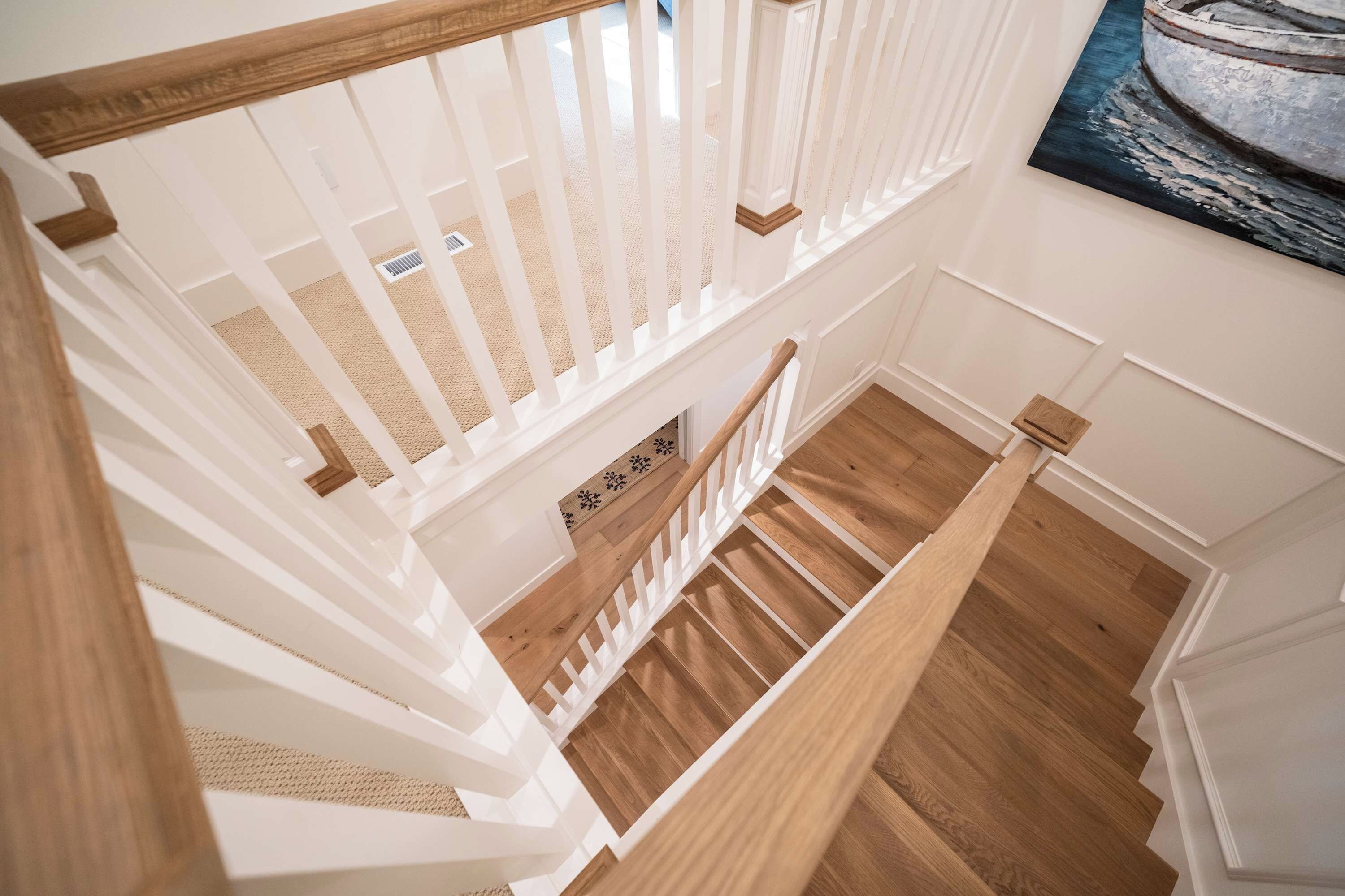 A staircase with white railings and wooden steps.