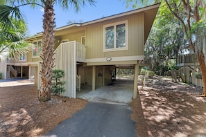 A two-story building with a covered entrance and a visible address number. - Seabrook Exclusives | 1151 Summerwind (Seabrook Island)