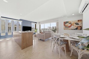 A modern living space with a kitchen, dining area, and seating. - Brand New Pet-friendly Condo - Private Pool (Cabo San Lucas)