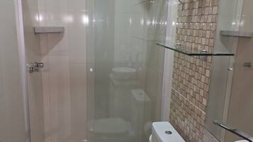 A modern bathroom with a glass-enclosed shower, a toilet, and a sink.