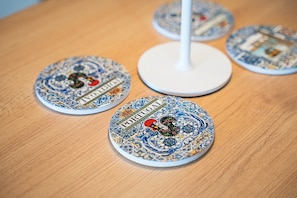A table with several round, patterned coasters with the word 'PORTUGAL' on them. - GuestReady - Cozy Porto Retreat with Balcony (Porto)