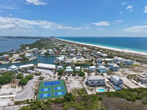 An aerial view of a coastal resort with multiple buildings, a marina, and a beach. - Beach View Perdido Key;  Beach Views, Heated Pool, Spa & Firepit (Pensacola)