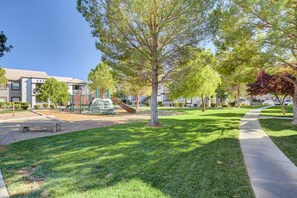 A residential area with a playground, a pathway, and houses. - Tuscano Condo Gem! SW Las Vegas Oasis (Las Vegas)