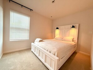 A bedroom with a single bed, a window with blinds, and a wall-mounted light fixture. - NEW - 8Beds 16People (Durham)