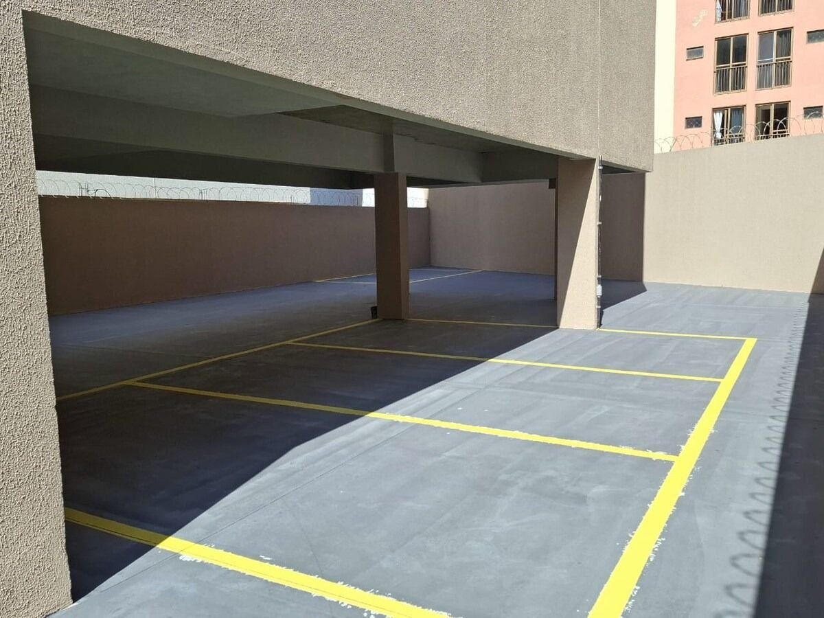 A parking garage with multiple levels and yellow lines marking parking spaces.