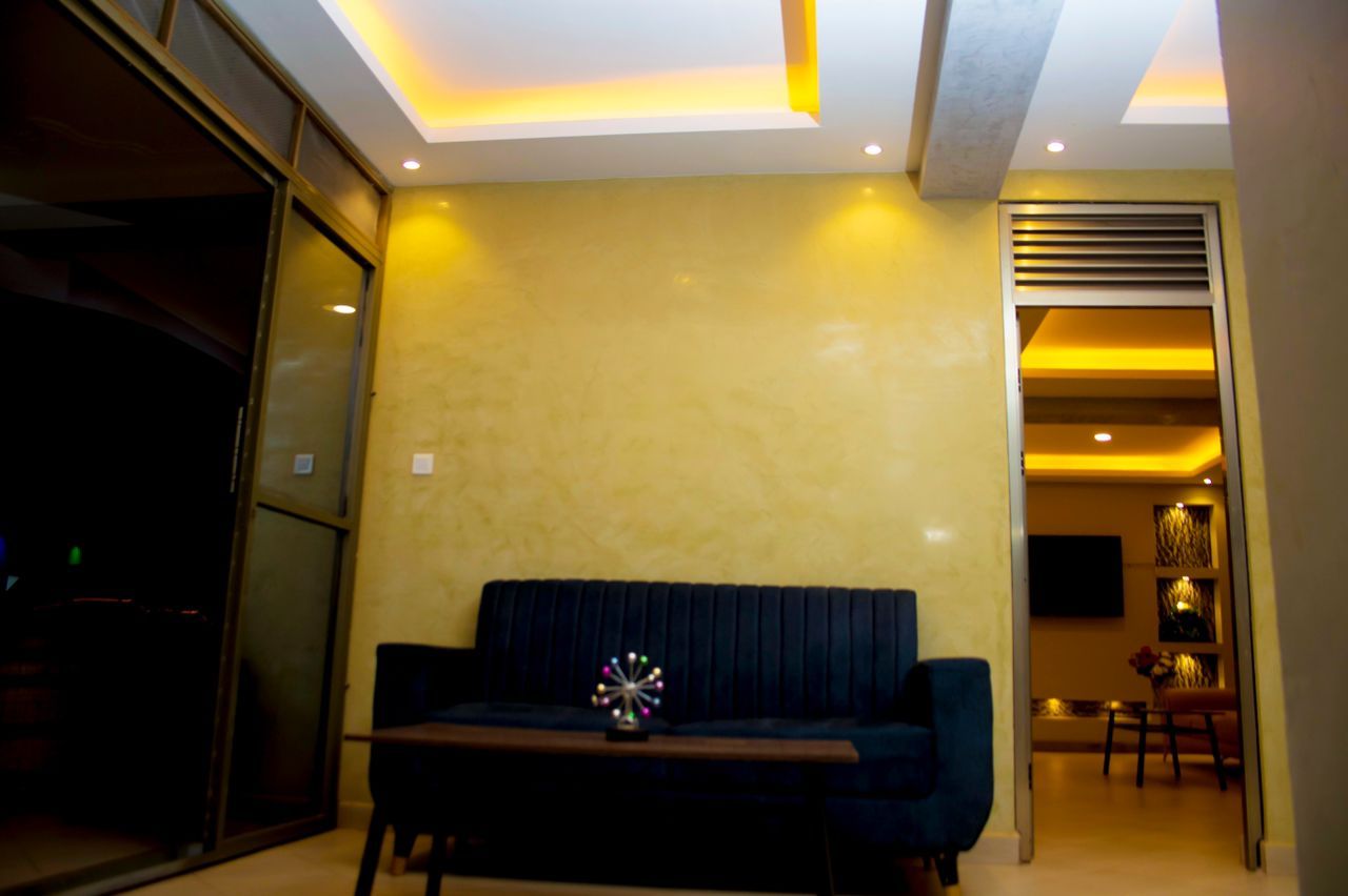 A modern living room with a sofa, a coffee table, and a television.