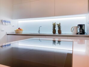 A modern kitchen with a built-in island, a stainless steel sink, and a coffee maker. - LuxRent Villa Smeralda Pool and Beach (San Teodoro)