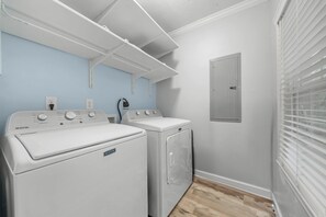 A laundry room with two Maytag washers and dryers, a power outlet, and a light switch on the wall. - Get After that Azalea Walk to Georgia Southern (Statesboro)