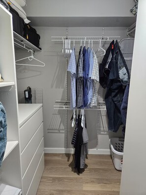 A walk-in closet with multiple shelves and hanging storage for clothes. - Spectacular Apt With Beach View (Carolina)