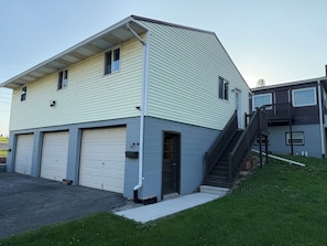 A two-story building with a garage, a covered driveway, and a small front yard. - Newly remodeled 2-bedroom apartment in wonderful Johnstown / Richland Township (Johnstown)