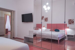 A modern bedroom with a large bed, bedside tables, a flat-screen TV, and decorative wall art. - Lele Rooms Vaticano (Roma)
