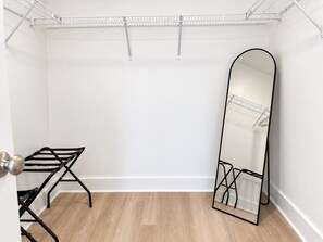 A room with a metal drying rack, a full-length mirror, and a white wall. - PCB Family Getaway, 3BR Townhome, Sleeps 6 - Community Pool (Panama City Beach)