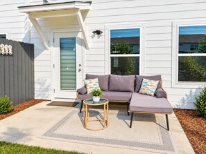 A white house with a gray fence, a gray door, and a gray exterior wall. - PCB Family Getaway, 3BR Townhome, Sleeps 6 - Community Pool (Panama City Beach)